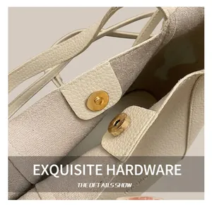 Detailed close-up of textured ivory leather bucket bag featuring a light gold magnetic closure