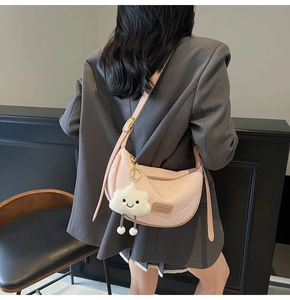 Pink crescent shoulder bag with white jacquard floral patterns and cloud charm