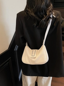 White lychee texture half-moon shoulder bag styled with a professional black blazer