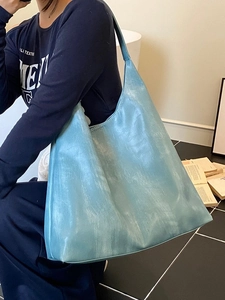 Minimalist light blue hobo tote bag with unique cloud texture for daily commuting fashion