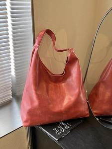Minimalist reddish brown faux leather tote bag with wide strap for daily commuting
