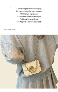 Detail of cream white faux leather girl's bag with crocodile texture and gold buckle