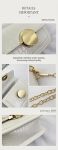 Close-up of white crocodile texture leather and golden metal clasp on a girl's handbag