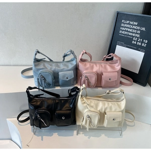 Detail view of stylish tote bags in four colors with functional front pockets and wide straps
