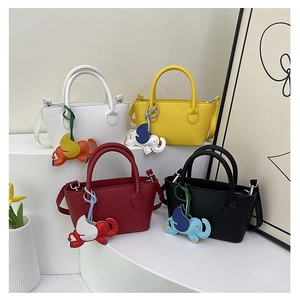 Minimalist crossbody bucket bags in four colors featuring cute elephant bag charms