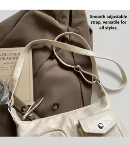 Detailed view of creamy white shoulder bag with adjustable strap and vintage buckle