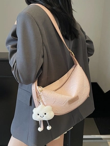 Pink crescent shoulder bag with embossed floral texture and cute cloud charm accessory