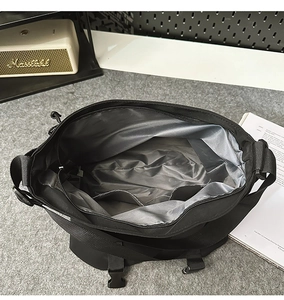 Top view of spacious messenger bag interior with grey lining and organized pockets