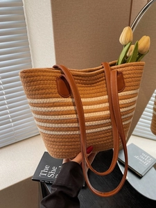 Striped woven cotton tote bag with brown leather handles for summer beach vacations