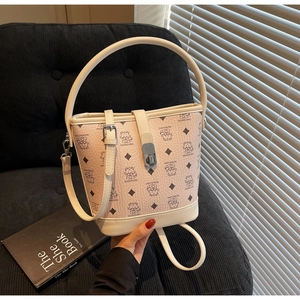 Detail of premium bucket bag with cartoon bear pattern and silver metal buckle