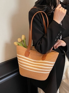 Striped woven rope tote bag with brown leather handles for summer beach vacations