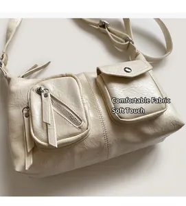 Close-up of off-white retro hobo bag showing PU leather texture and functional pockets