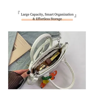 Detail view of large capacity interior for white bucket bag with pebble leather texture