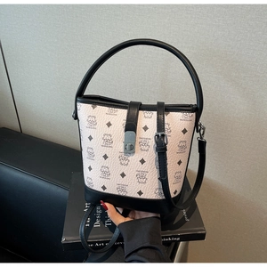 Close-up of contrast bucket bag with cat pattern print and black leather trim