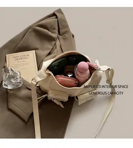Detail view of the spacious interior of an off-white multi-pocket hobo bag for daily essentials