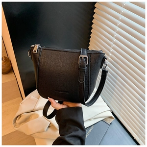 Détail du sac seau noir en cuir grainé avec fermeture éclair argentée et boucle réglable