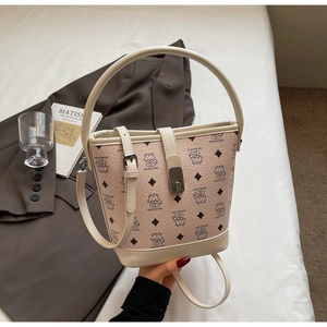 Detail of beige bucket bag featuring cartoon prints and silver metallic lock closure