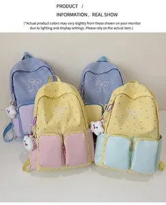 Detail of color-block backpacks featuring polka dots, bow embroidery, and star charms