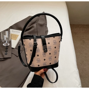 Detailed view of pink bucket bag with cartoon prints, top handle, and golden metal lock