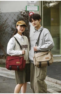 Close-up of durable canvas messenger bags with adjustable buckles and brand leather patch