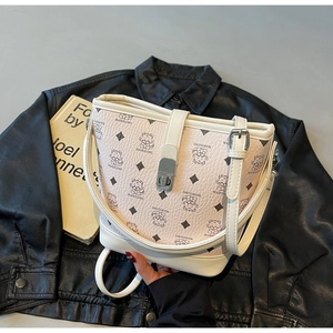 Detailed macro view of the pink bucket bag featuring a dragon graphic and white leather handle