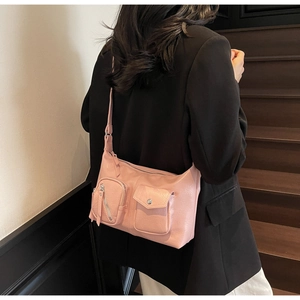 Detailed back view of a pink PU leather bag with multi-pockets and soft texture