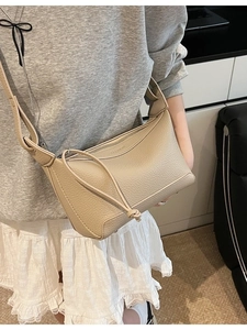 Chic beige hobo crossbody bag with lychee texture pattern and sleek zip closure