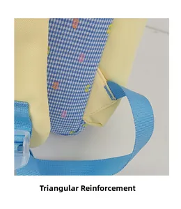 Detail of color-block backpack showing reinforced triangle stitching on blue shoulder straps