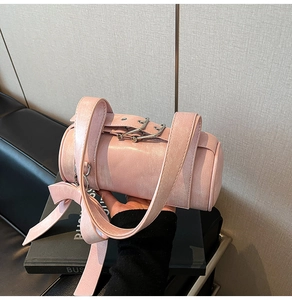 Detailed view of the large decorative bow and textured faux leather on the pink Boston bag