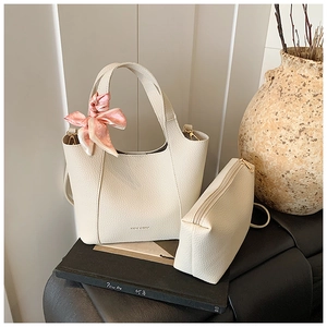 Detail of cream-colored lychee pattern bucket bag with silk scarf and matching coin purse