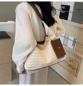 Detail of hand-woven tote bag with brown leather straps and small matching card holder pouch