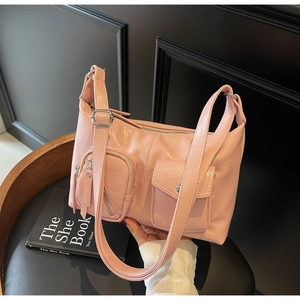 Pink faux leather hobo bag with wide shoulder strap and functional utility pockets