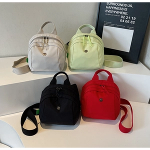 Mini nylon backpacks in white, green, black and red shown in a modern group display