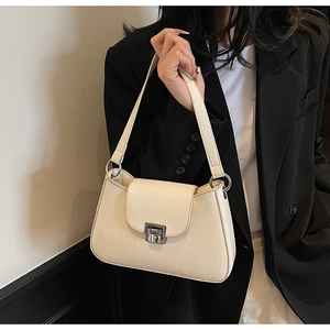 Detail view of cream-white vintage textured leather shoulder bag with square metal clasp