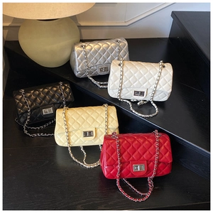 Detailed display of five colorful quilted chain bags with metal turn-lock closures
