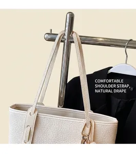 Detail of off-white tote bag showing lychee grain leather and double stitching