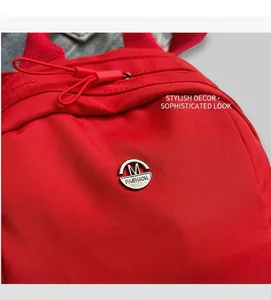 Close-up of red nylon shell bag featuring a metal M logo and fashion lettering