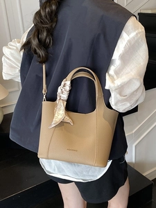 Brown lychee leather tote bag with decorative heart scarf and versatile shoulder strap
