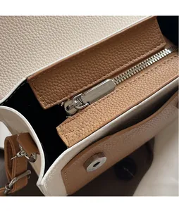 Macro detail of lychee grain leather handbag with silver zipper and contrast stitching