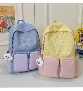 Detail of color-block backpack with ribbon embroidery and cute star plush pendant