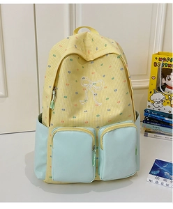 Detail view of the multi-pocket structure and blue color-block design on the backpack
