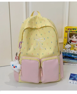 Detail view of yellow plaid backpack with pink zip pockets and plush star charm