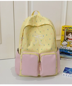 Detailed view of floral school backpack with yellow plaid and pink utility pockets