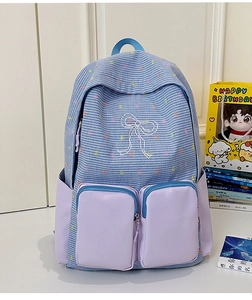Detail of color-block plaid backpack with bow print and purple pocket compartments