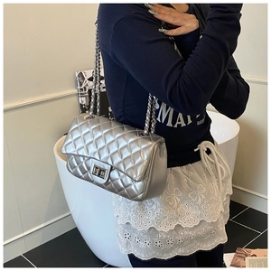 Silver quilted chain crossbody bag with metallic finish and metal turn-lock closure
