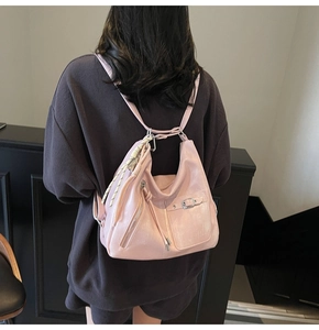 Detailed back view of pink large tote bag showing textured faux leather and woven charm