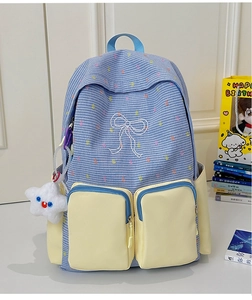 Detailed shot of color-block plaid school backpack with star plush pendant and bow embroidery