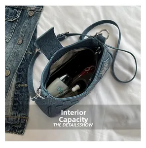 Top view of denim shoulder bag showing spacious interior with zipper pocket and essentials