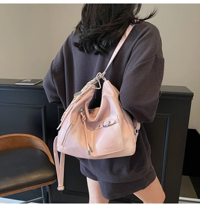 Pink pearlescent Hobo tote bag showing capacity and fit on shoulder in a lifestyle setting