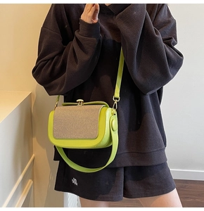 Detail view of neon green leather crossbody bag with beige twill fabric patchwork texture